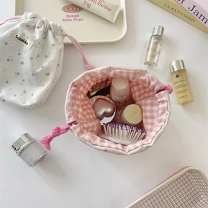 Detail of floral drawstring storage bags with toiletries and cosmetic bottles