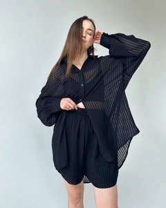 Detailed texture of black vertical striped semi-transparent shirt and high waist shorts set