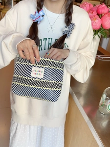Dopamine-style colorful woven cosmetic bag with black and white stripes and logo