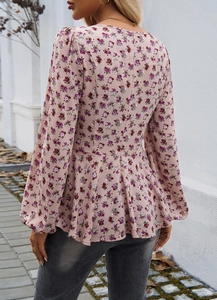 Back view of elegant floral puff sleeve blouse with cinched waist and lantern sleeves