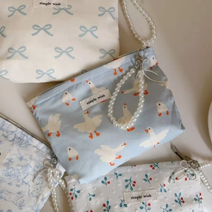 Detailed macro view of cotton mini bag with pearl handle and simple wish label