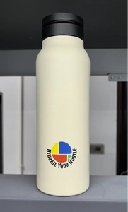 Close-up of cream insulated water bottle with black lid and Hydrate Your Hustle logo