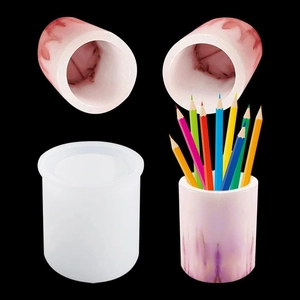 Detail of cylindrical silicone mold with marble effect pencil holder and colored pencils