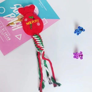 Detail of Christmas dog chew toy with plush gift bag head and colorful woven cotton rope knot