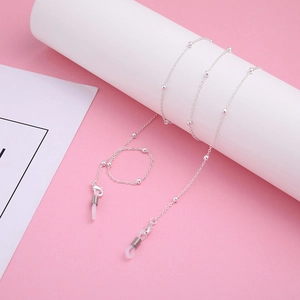 Detail of silver bead eyewear chain with lobster clasps and clear silicone loops