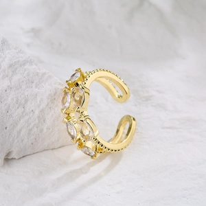 Macro shot of an 18K gold-plated ring with shimmering marquise-cut zircons and beaded texture