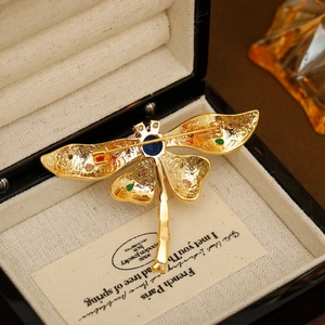 Colorful zircon dragonfly brooch in 18K gold plating shown from the detailed back view
