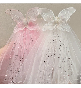 Detail of glittery mesh bow hair clips with faux pearls and butterfly lace for girls