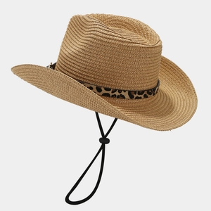 Detail of straw cowboy hat with leopard print band and adjustable black chin strap