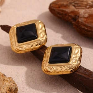 Macro shot of 18K gold plated hammered square stud earrings with black resin inlay