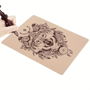 Beige silicone tattoo practice skin featuring a geometric wolf head and dreamcatcher design