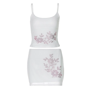Two-piece white set featuring slim fit camisole and mini skirt with pink rhinestone flowers