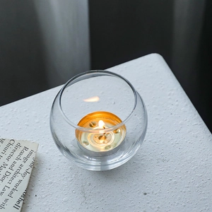 Minimalist Nordic round crystal glass candle holder with a lit tealight for home decor