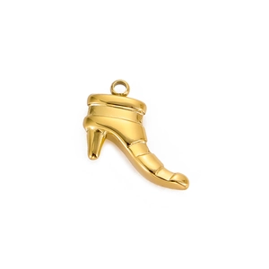 Macro detail of a polished gold high heel boot pendant for necklaces or bracelets