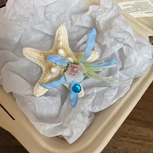 Starfish hair clip with blue silk flower and rhinestone for beach vacations