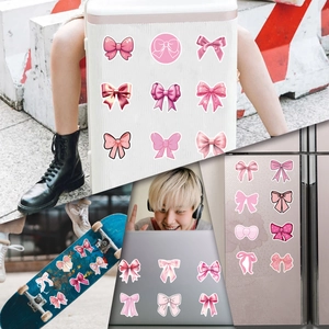 Pink Coquette Bows stickers shown on suitcase, skateboard, laptop, and refrigerator