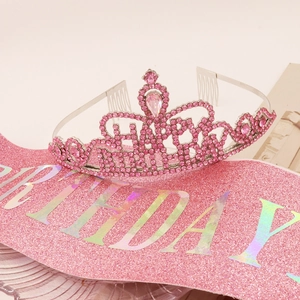 Close-up of pink crystal crown and glittery HAPPY BIRTHDAY sash for girls