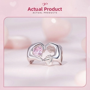 Macro detail of S925 silver charm featuring hands holding a pink heart crystal