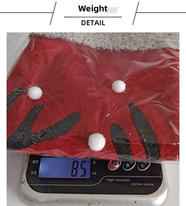 Detail showing red Christmas stocking weight of 85g with plush deer head and antlers
