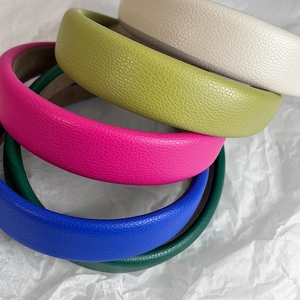 Macro shot of padded headbands featuring premium lychee grain leather in multiple colors