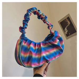 Close-up of pleated handbag showing satin glossy rainbow gradient texture and ruched handle