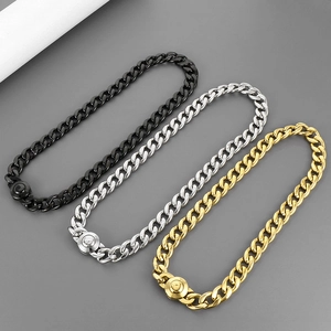Detailed close-up of Cuban link bracelets in gold, silver, and black with Z-letter clasps