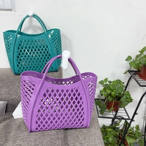 Detail of purple and green silicone hollow beach bags with reinforced wide handles