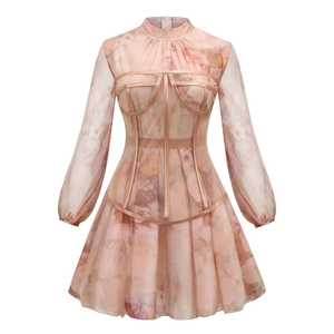 Detail of pink floral mesh dress featuring a structured waist corset and sheer sleeves