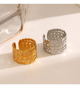 Detailed close-up of 18K gold plated stackable rings with daisy and twisted textures