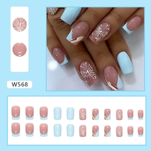Macro shot of 24pcs blue and nude fake nails featuring butterfly art and gold lines