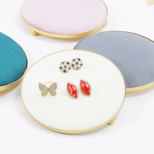 Round velvet jewelry display trays with gold frames for rings and earrings