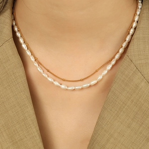 Elegant layered freshwater pearl necklace with gold bead chain and rose pendant charm