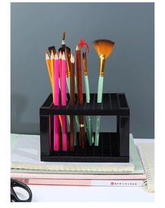 Detail of 96-hole black plastic paintbrush holder rack with grid design for organizing pens