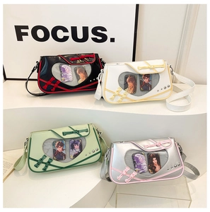 Detail view of heart-shaped window bags with Chinese frog buttons and anime card inserts
