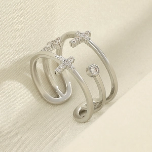 Detailed view of silver layered cross ring with sparkling cubic zirconia pavé stones