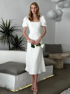 Detail of white satin midi dress with square neckline, puff sleeves and high waistline