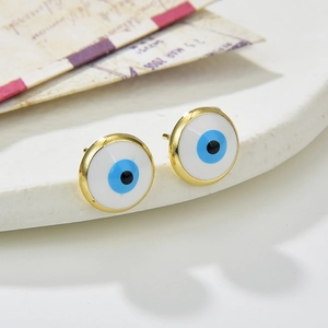 Chic gold-plated copper evil eye stud earrings for women on a textured white display base