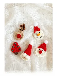 Detail of five handmade crochet Christmas ornaments including reindeer and snowman