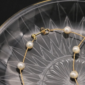 Exquisite handmade woven pearl earrings with 18K gold-plated twisted copper wire design