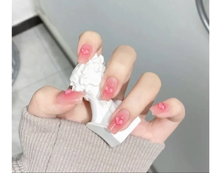 Detailed view of pink translucent jelly heart charms applied to square-oval nails