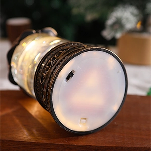Close-up of the battery compartment and power switch on the vintage Christmas snow globe