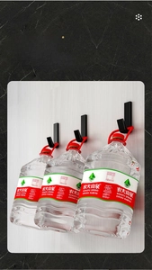 Three heavy-duty black J-shaped adhesive hooks showing high load capacity on a wall