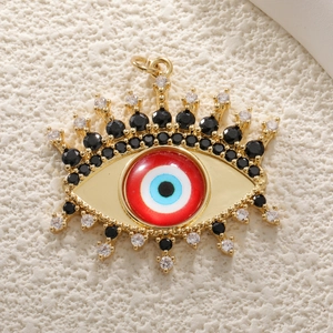 Macro detail of Evil Eye charm with blue crystals and gold plating on stone