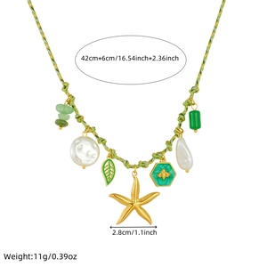Detail of green woven necklace with starfish, bee, leaf, pearl, and stone charms
