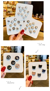 Detail shot of mini decorative brooches featuring pearl, clover, and rabbit shapes