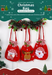 Close-up of three Christmas velvet drawstring bags with snowman, reindeer and Santa motifs