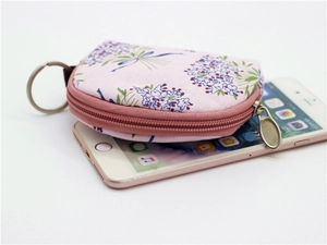 Compact pink floral fabric coin purse with semicircular design and metal keyring