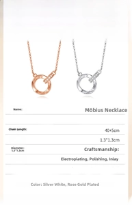 Detail showing intertwined double ring pendant with crystals and All In Love engraving