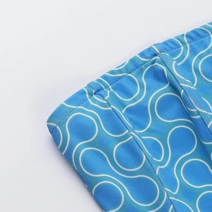 Close-up of blue and white wave print fabric on a tight-fitting one-piece swimsuit
