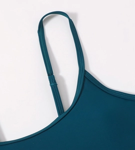 Detail of high-elasticity fabric sewing and shoulder strap seam on dark teal bikini